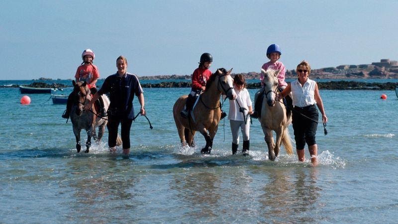 Vazon Bay is a popular spot for surfing and horseriding